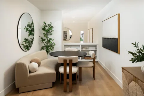 a view of a livingroom with furniture and a potted plant