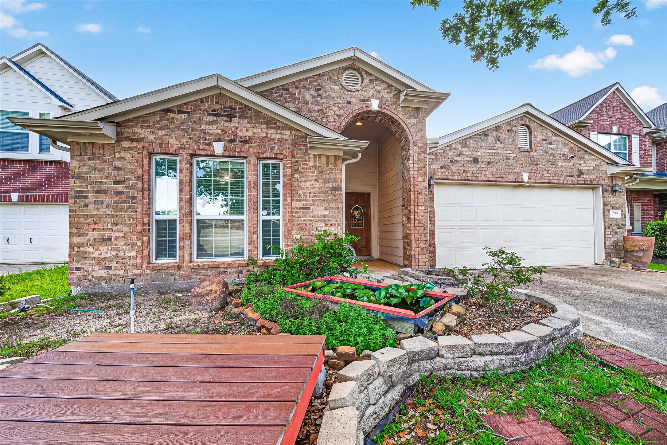 16715 Mackenzie Mesa Drive Spring, TX 77379 - Photo 4 of 50 a front view of a house with garden