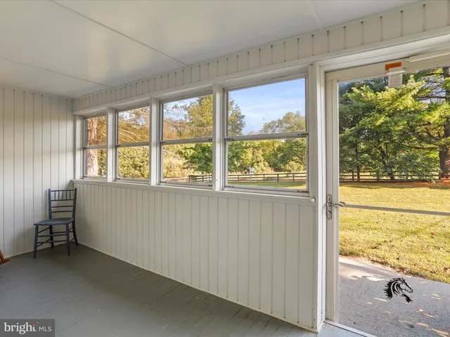 a view of kitchen with furniture and electronic appliances