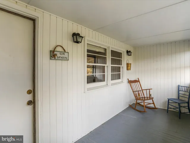 a view of a kitchen with furniture and a refrigerator
