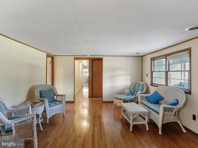 a room with furniture and a kitchen view