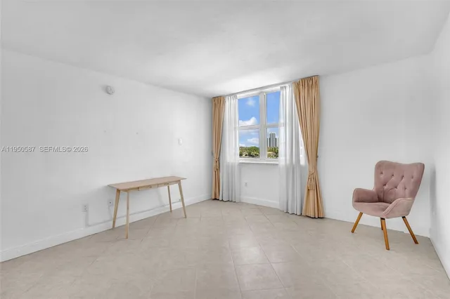 a patio with glass top table and chairs