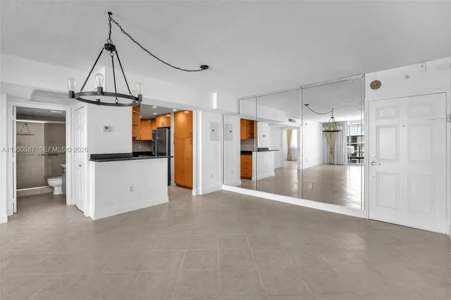 a view of kitchen with refrigerator stove and chair