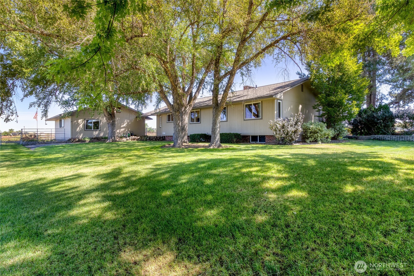 1135 Locher Road Touchet, WA 99360 - Photo 4 of 40 a view of a house with a big yard and large trees