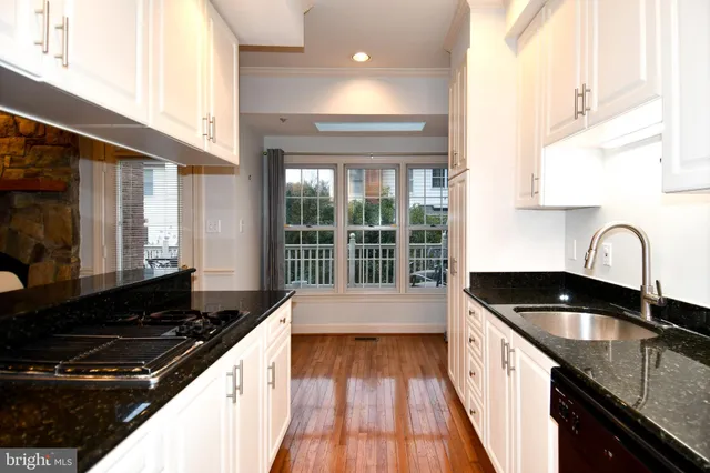 a kitchen with a sink and a stove top oven