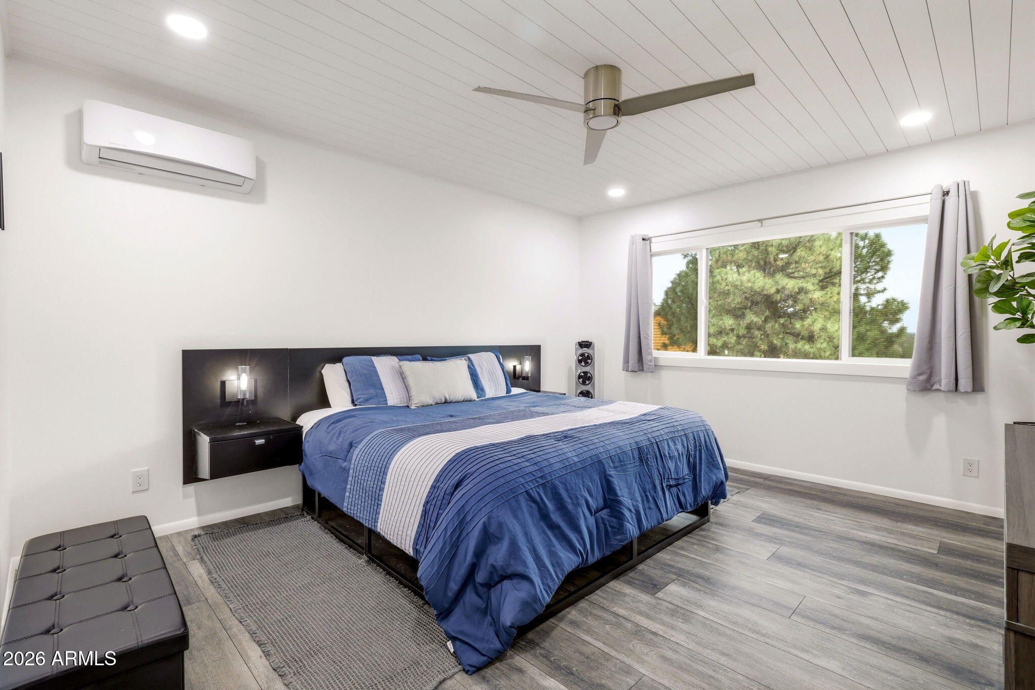 2287 Richenbacher Circle Overgaard, AZ 85933 - Photo 26 of 46 a bedroom with a large bed and a window