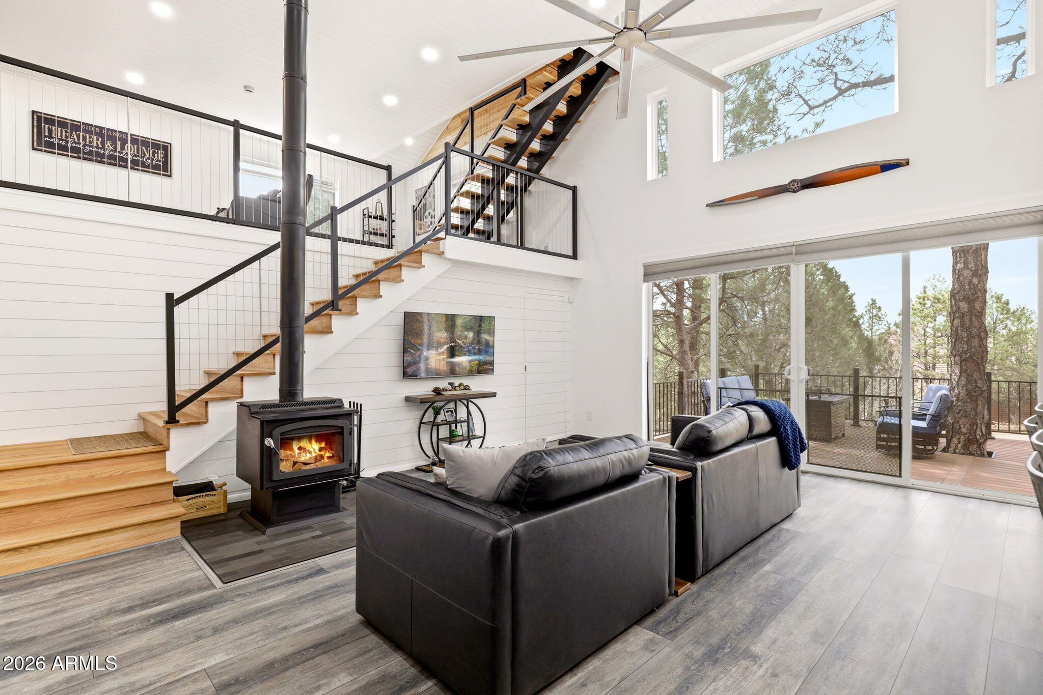 2287 Richenbacher Circle Overgaard, AZ 85933 - Photo 9 of 46 a living room with furniture large window wooden floor and furniture