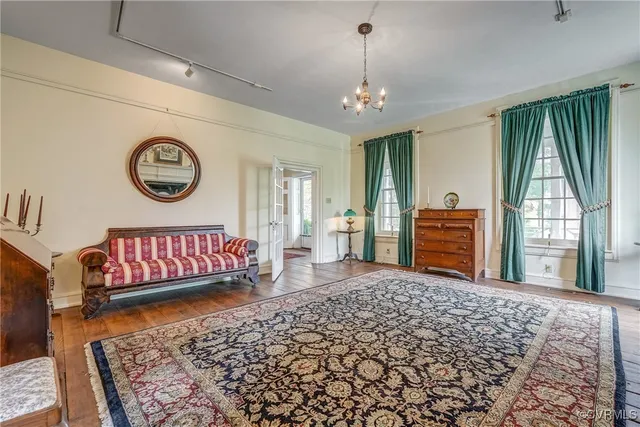 a spacious bedroom with a large bed and a window