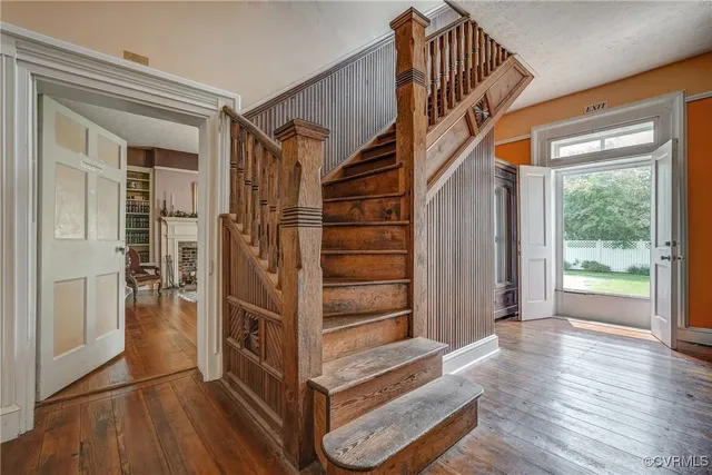 a view of a roof deck with table and chairs a barbeque with wooden floor and fence