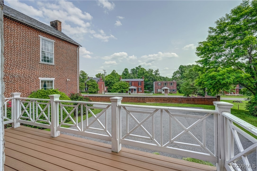 23 Courthouse Road Buckingham, VA 23921 - Photo 42 of 50 a view of a roof deck with table and chairs a barbeque with wooden floor and fence