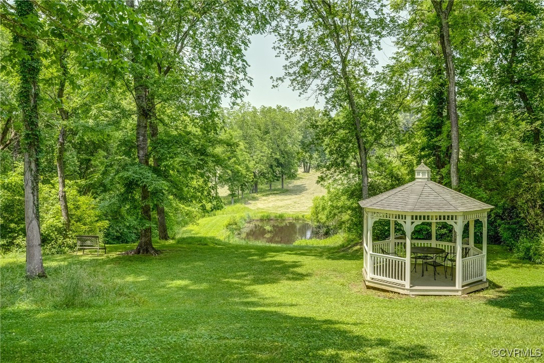 23 Courthouse Road Buckingham, VA 23921 - Photo 47 of 50 a backyard of a house with table and chairs under an umbrella