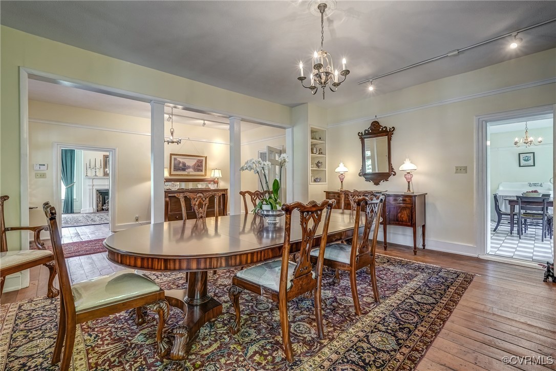 23 Courthouse Road Buckingham, VA 23921 - Photo 10 of 50 a dining room with wooden floor a chandelier a wooden table and chairs