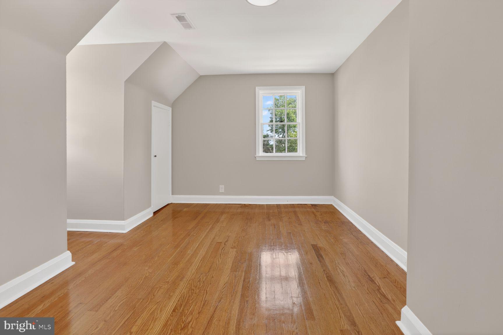 315 East Cold Spring Lane Baltimore, MD 21212 - Photo 16 of 25 an empty room with wooden floor and windows