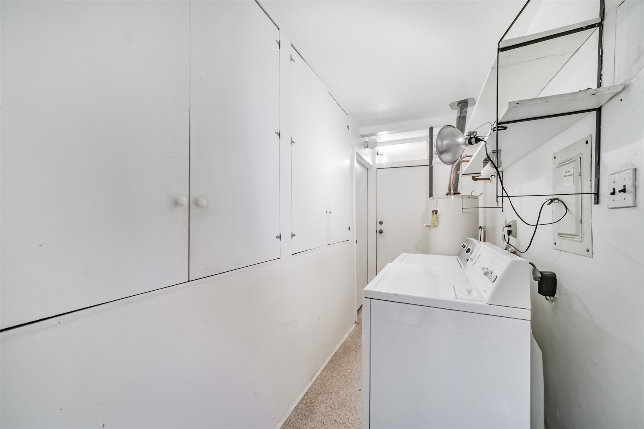 7510 Romney Road Houston, TX 77036 - Photo 26 of 32 Utility/laundry room off the den has access to the backyard, garage, and an additional storage closet.