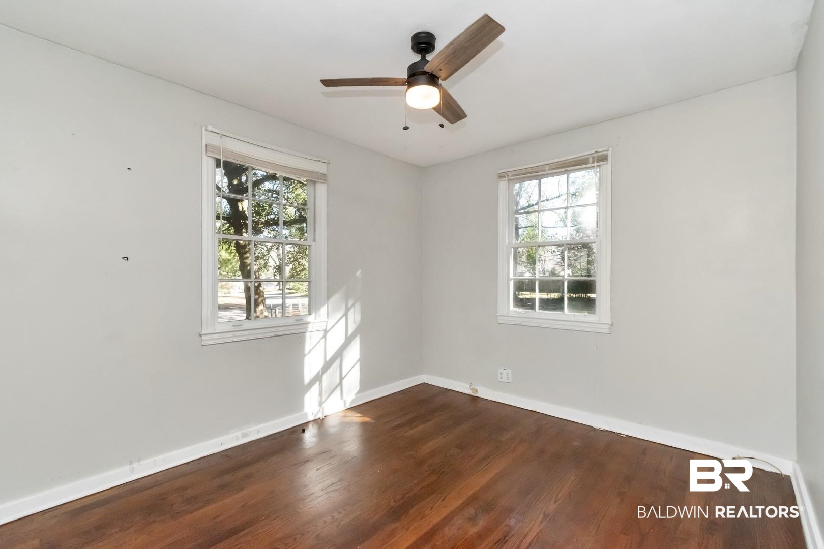 5001 Hillwood Circle South Mobile, AL 36608 - Photo 13 of 20 Unfurnished room featuring a ceiling fan, baseboards, and dark wood-type flooring