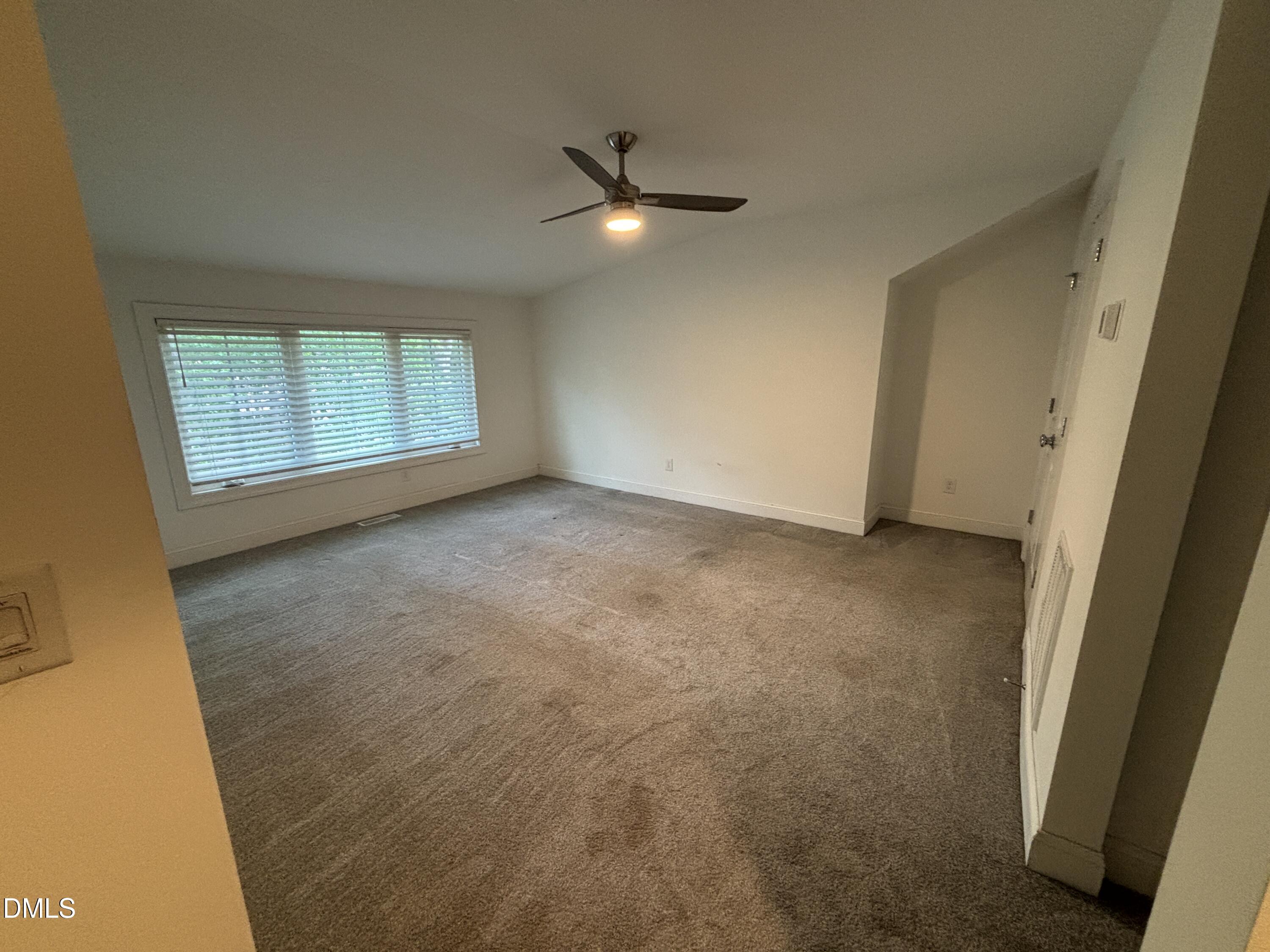 5710 Parker Pnes Court Raleigh, NC 27609 - Photo 68 of 78 an empty room with a ceiling fan and windows