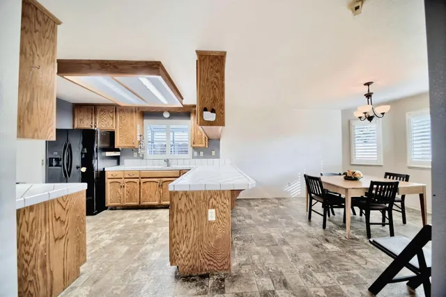 a spacious bathroom with a granite countertop sink mirror and shower