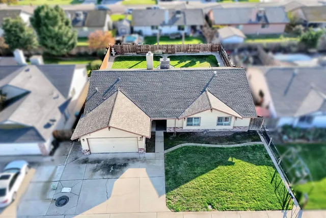 an aerial view of house with yard