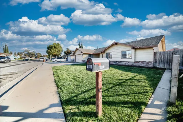 a aerial view of a house next to a yard and deck