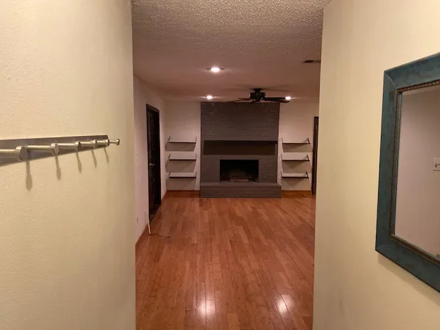 a view of an empty room and fire place