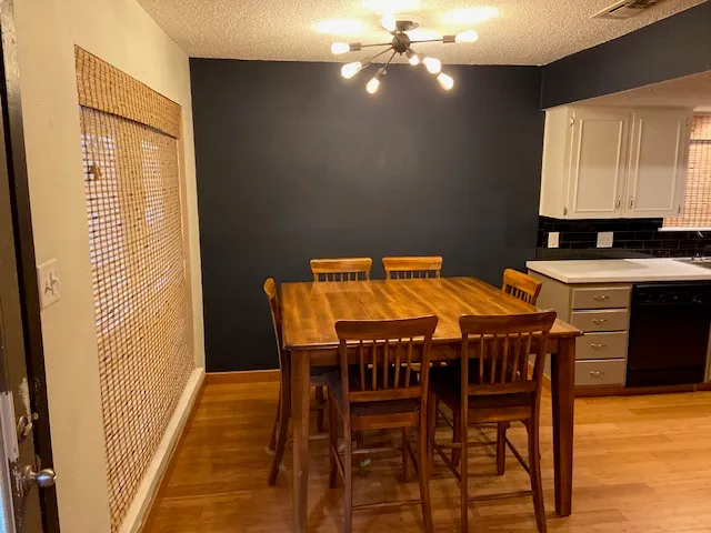 a view of a dining room with furniture and wooden floor
