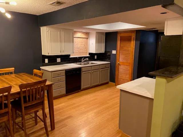 a kitchen that has a sink and a table in it