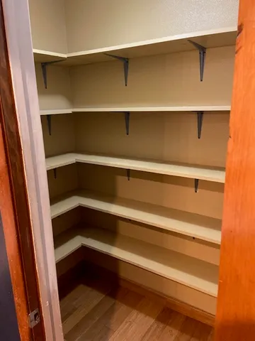 a view of walk in closet with empty racks