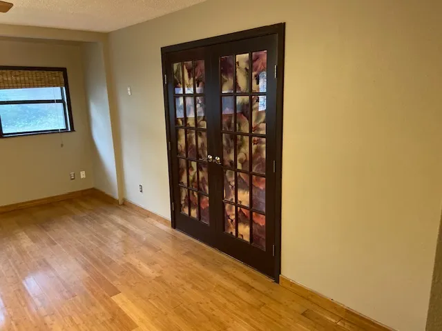 a view of a hallway with wooden floor and a bookshelf