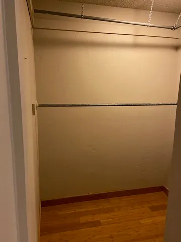 a view of a refrigerator with wooden floor