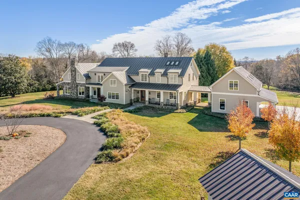 a view of a white house with a yard patio and deck