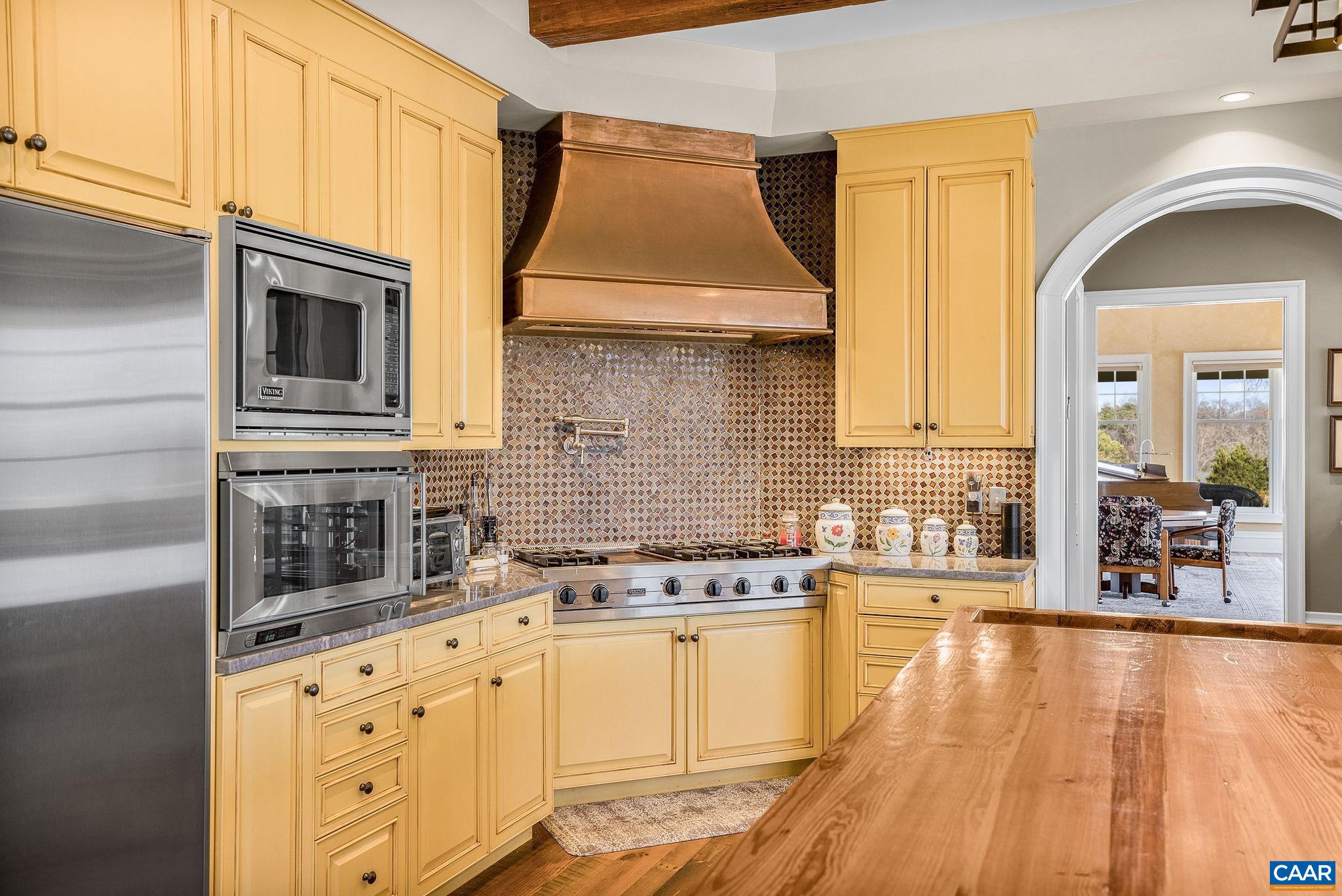 2687 Milton Farm Charlottesville, VA 22902 - Photo 55 of 75 a kitchen with granite countertop a stove a sink and white cabinets