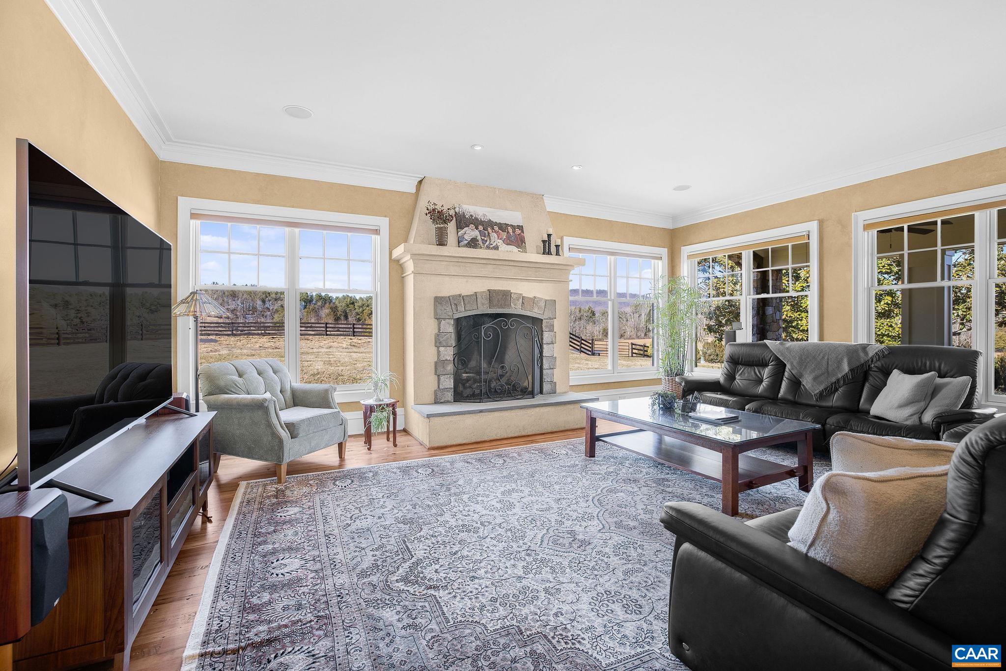 2687 Milton Farm Charlottesville, VA 22902 - Photo 63 of 75 a living room with furniture a flat screen tv and a fireplace