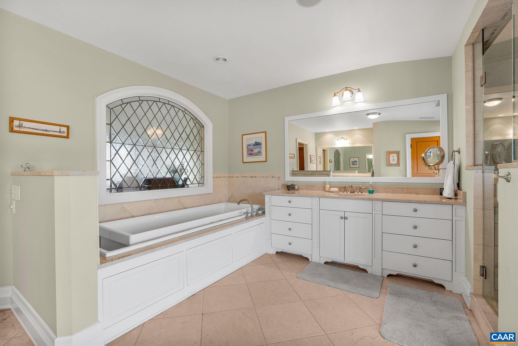 2687 Milton Farm Charlottesville, VA 22902 - Photo 69 of 75 a spacious bathroom with a tub sink and mirror