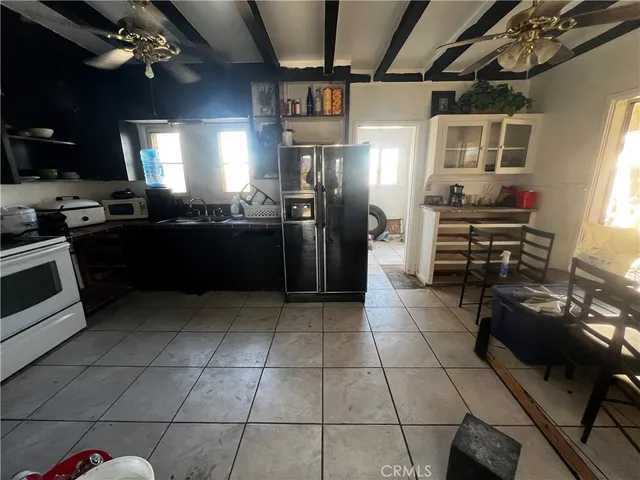 a kitchen with granite countertop a stove a sink dishwasher and a refrigerator