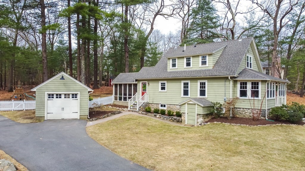 a front view of a house with a yard outdoor seating and garage