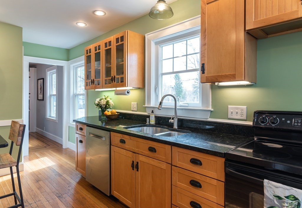 93 Gould Road Andover, MA 01810 - Photo 6 of 39 a kitchen with granite countertop stainless steel appliances a sink window and cabinets