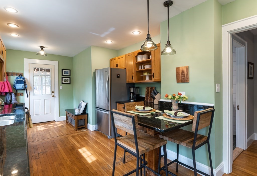 93 Gould Road Andover, MA 01810 - Photo 7 of 39 a dining room with furniture and wooden floor