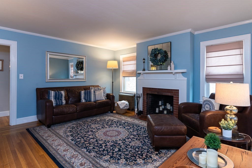 93 Gould Road Andover, MA 01810 - Photo 8 of 39 a living room with furniture and a fireplace
