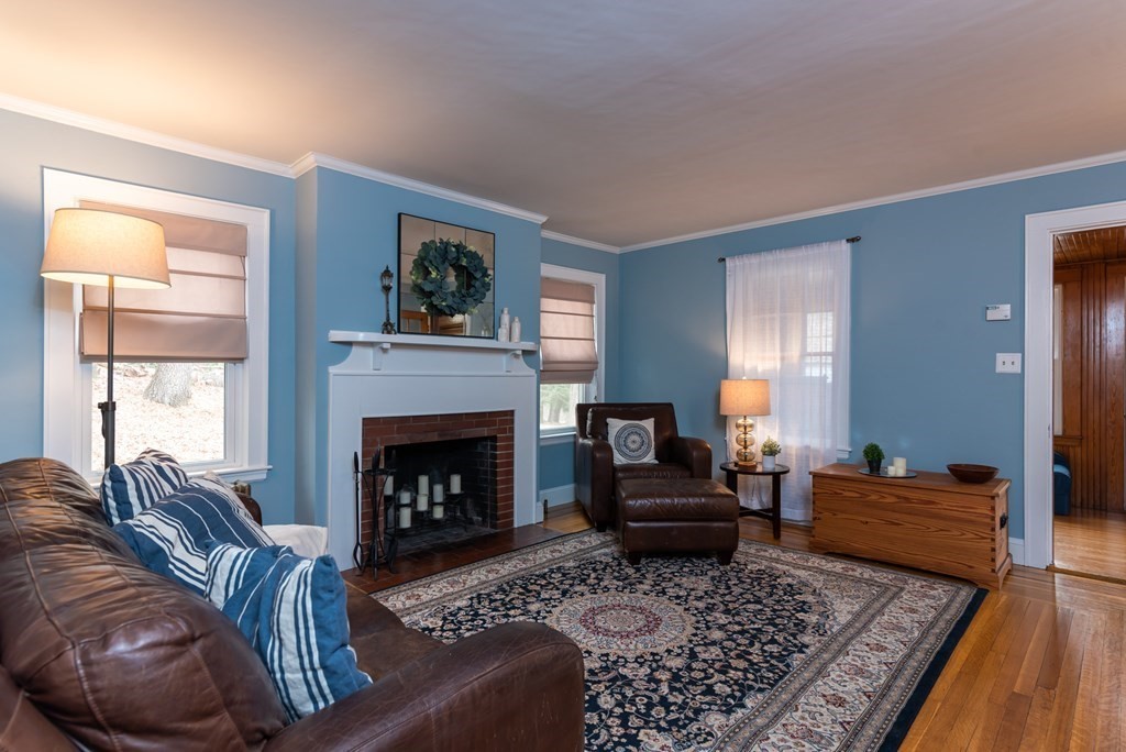 93 Gould Road Andover, MA 01810 - Photo 9 of 39 a living room with furniture and a fireplace