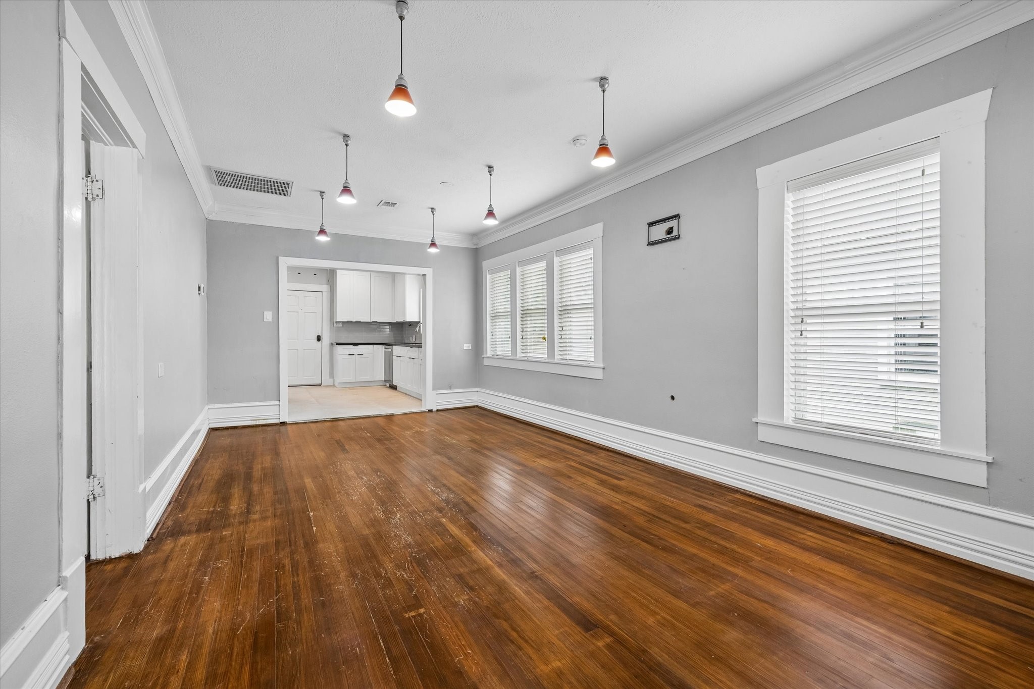 1201 Tulane Street Houston, TX 77008 - Photo 13 of 31 This open living and dining space is ready for dinner parties, slow weekends, and everyday Heights living with a comfortable flow into the updated kitchen. Rich hardwood floors, fresh neutral paint, crisp trim, stylish lighting, and timeless Craftsman details make the heart of the home feel warm, polished, and easy to love.