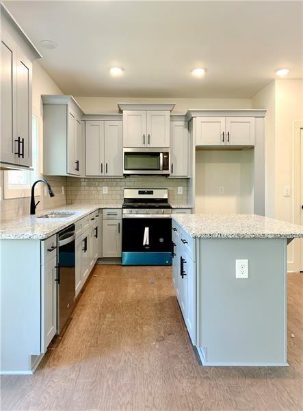 27 Bridgestone Way Cartersville, GA 30120 - Photo 11 of 31 a kitchen with stainless steel appliances granite countertop a stove top oven a sink and a refrigerator