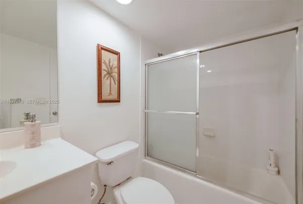 a bathroom with a toilet a sink and shower