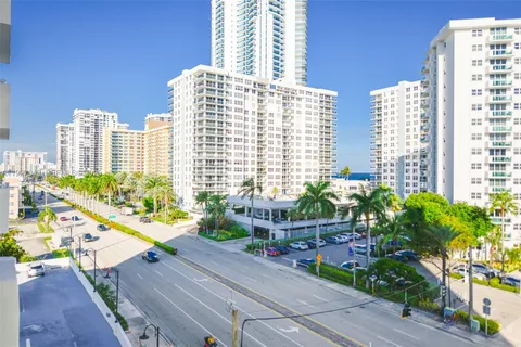 a front view of a building with plants