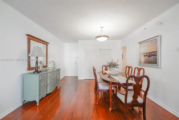 a view of a dining room with furniture and wooden floor