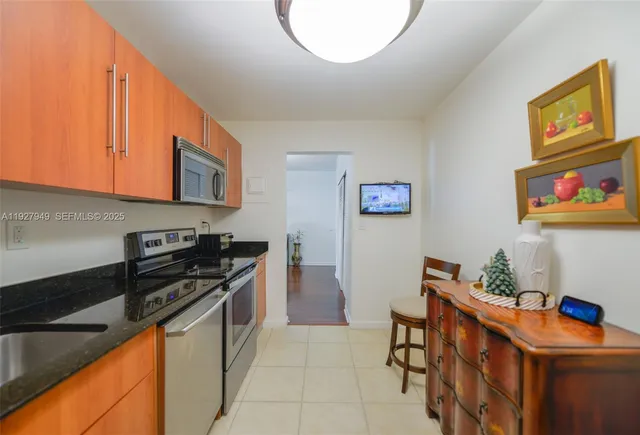 a kitchen with stainless steel appliances granite countertop a stove and a microwave