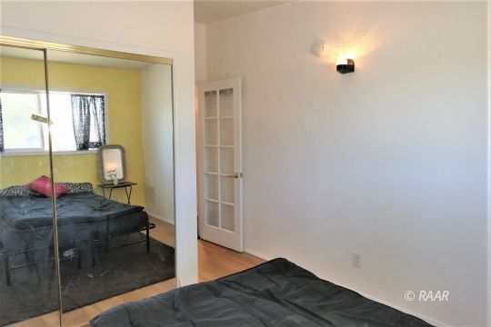 1263 Primrose Street Ridgecrest, CA 93555 - Photo 24 of 35 a living room with a couch and wooden floor
