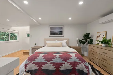 a bedroom with a large bed and a potted plant