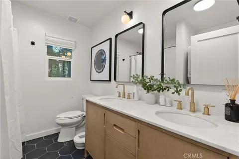 a bathroom with a sink a toilet and mirror