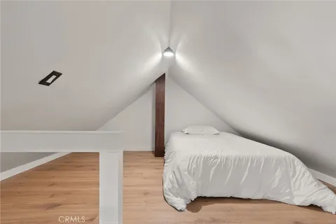 a bedroom with a bed and a night stand