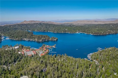 an aerial view of a houses with a lake view
